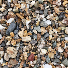 Photo of pebbles on the beach. Photos of stones on the street. Rocky beach, summer river bank. Sea holidays, vacations and vacations.