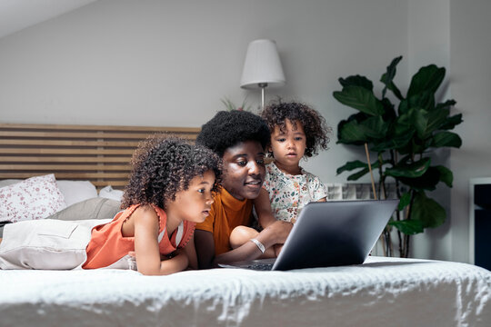 Happy Family Using Laptop