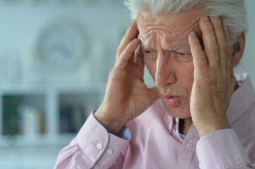 sad sick senior man with  headache