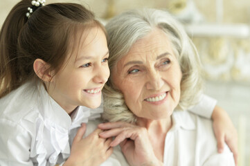 Grandmother  with her cute  granddaughter smiling