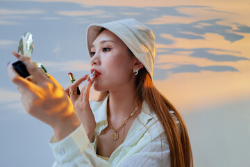 portrait of fashion Asian beautiful women using lipstick