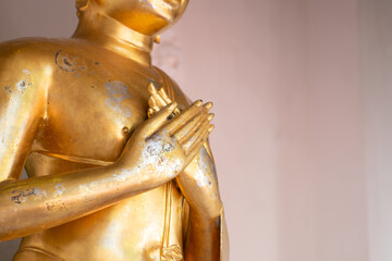 Close up old Buddha statue with raw of Brass. Hand of buddha statue with two hand stamp with chest....