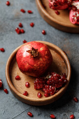 Ripe juicy pomegranate on grey background. Food background