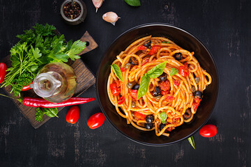 Spaghetti alla puttanesca - italian pasta dish with tomatoes, black olives, capers, anchovies and...