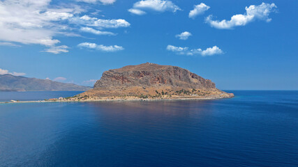 Fototapeta premium Aerial drone photo of beautiful castle and medieval old city of Monemvasia in the heart of Lakonia with beautiful clouds and deep blue sky, Peloponnese, Greece