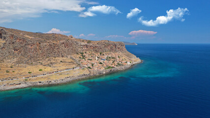 Aerial drone photo of beautiful castle and medieval old city of Monemvasia in the heart of Lakonia with beautiful clouds and deep blue sky, Peloponnese, Greece