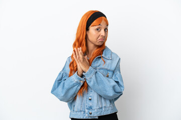 Young woman with orange hair isolated on white background scheming something