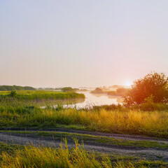 Obraz premium Sunrise in a light fog on a small river