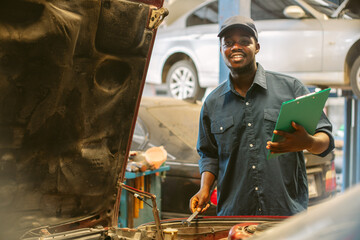 African maintenance male checking car, service via insurance system at Auomobile repair and check...