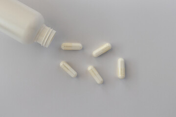 topview of taurine capsules, with negative space. dietary supplement copyspace. mental wellbeing and personal health concept