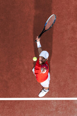 Tennis player hitting ball