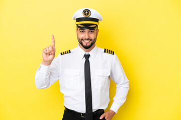 Airplane arab pilot man isolated on yellow background pointing up a great idea