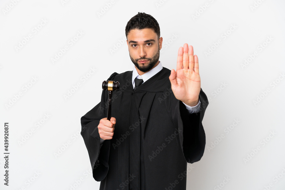 Wall mural judge arab man isolated on white background making stop gesture