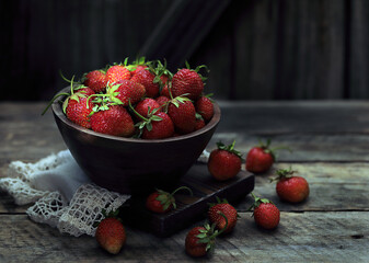 strawberries in a bowl  on a wooden background