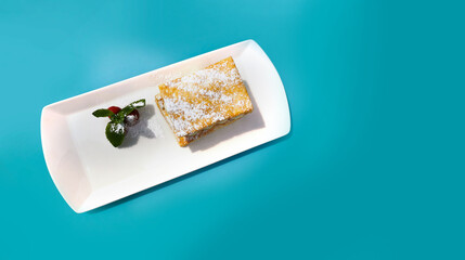 Dessert on white plate with green background. copy space.