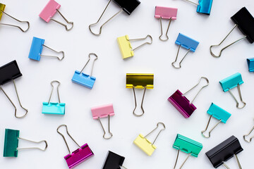 Colorful office paper clips on white background.