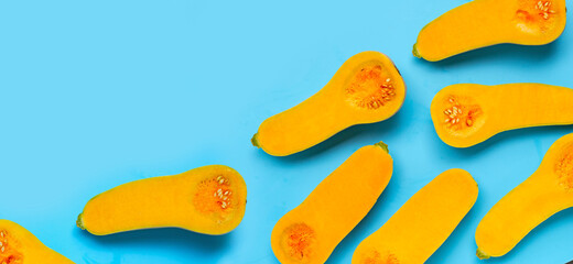 Cut butternut squash on blue background.