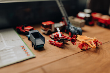 Selective focus shot of different toys on a wooden surface with blurred background © Doralin Samuel/Wirestock