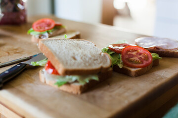Sandwich making on a cutting board.