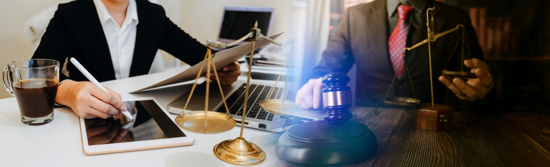 Business and lawyers discussing contract papers with brass scale on desk in office. Law, legal services, advice, justice and law concept picture with film grain effect