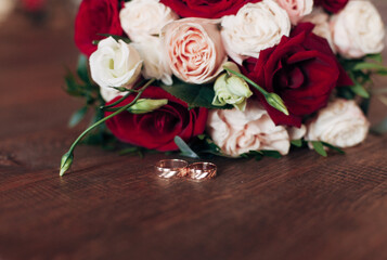 wedding rings and a bouquet of roses
