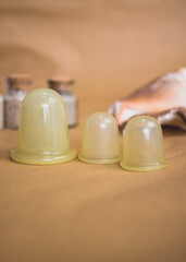 Vacuum cup for anti cellulite massage on the brown background and nautilus theme.