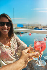 couple toasting the beginning of summer, cheers cups and glass, summer concept