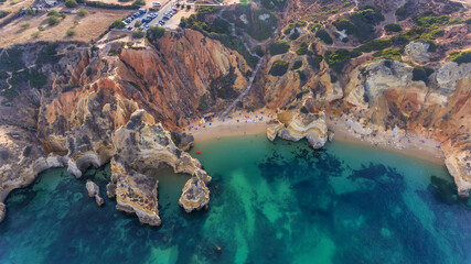 Camilo Beach in Lagos, Algarve - Portugal. Portuguese southern golden coast cliffs. Sunny day aerial view.
