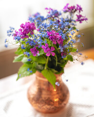 Flowers from the field in a copper vase