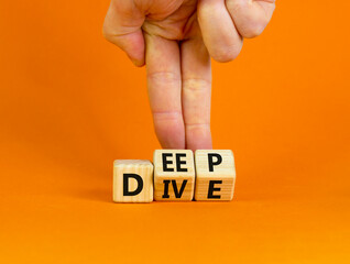 Deep dive symbol. Businessman turns wooden cubes with words 'Deep dive'. Beautiful orange background. Deep dive and business concept. Copy space.