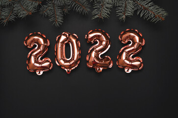 Shiny balloon symbols 2022 with glitters on festive background.
