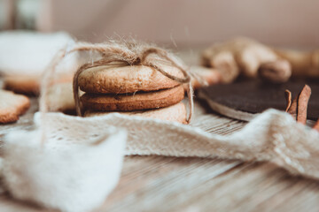 Close up of homemade ginger cookies, cinnamon, ginger on a wooden table. Copy space. Retro toned image, flat lay