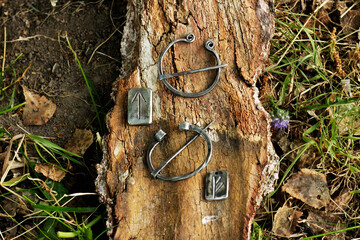 Iron runes Stock Photo laid out with the attributes of knights against a background of forest,...