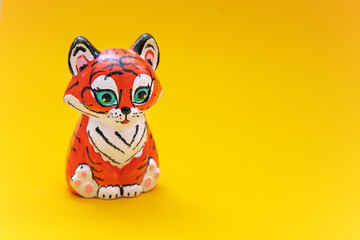 toy figurine tiger on yellow background