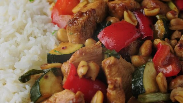 Kung Pao Chicken with Peppers and zucchini with rice. rotating video
