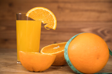 orange on the table, measuring tape and orange juice © Fantastic