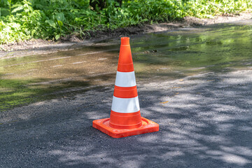 Orange traffic cone on a paved road