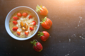 Healthy food. Delicious oatmeal with strawberry slices. Breakfast