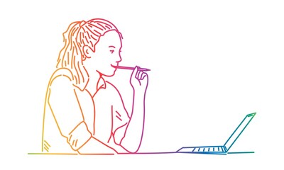 Girl holding pencil in mouth and looking at laptop.