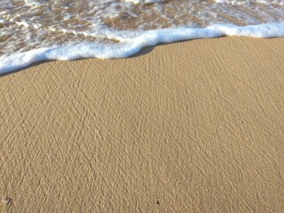 Fototapeta na wymiar Sand and sea foam. Summer photo. Beach, sea coast