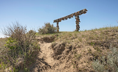 Old cowboy boots nailed to a rail in the Great Sandhills (Sand Hills) near Sceptre, Saskatchewan,...