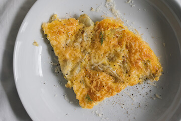 Fennel frittata with parmesan cheese on white plate
