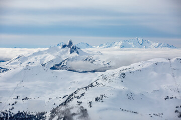 Fototapeta na wymiar Whistler Mountain, Symphony and Harmony ski lifts with Black Tusk & Tantalus Range