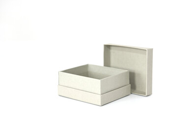 Gift mini box in gray color made of designer paper on a white background with an open lid