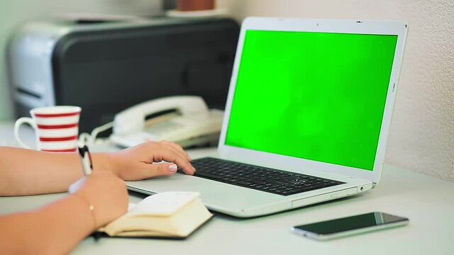 woman taking pictures without face type on laptop keyboard in home office