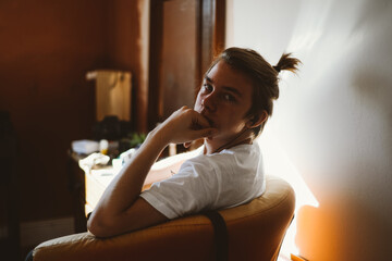  Young man sitting in his room