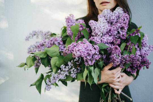 Woman with big bouquet of lilac