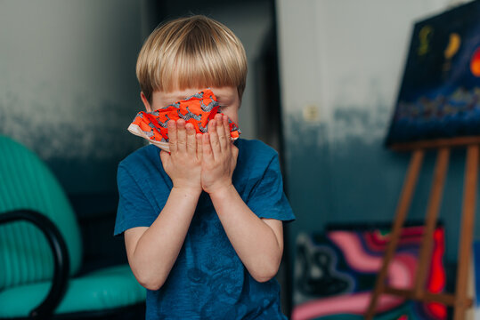 Kid Cleaning His Face With A Napkin