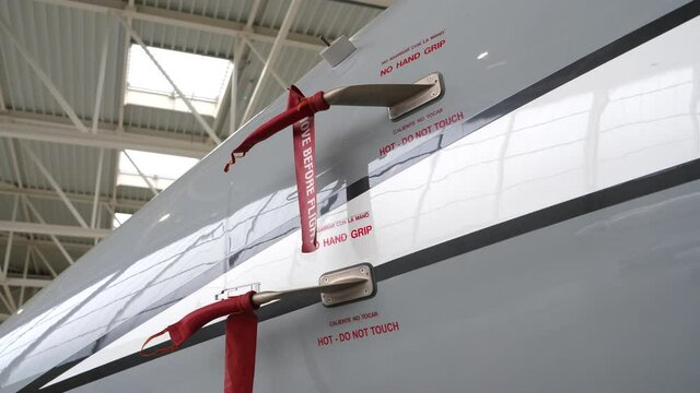 Steady gimbal movement around jet plane, covered pitot tube in hangar