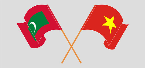 Crossed and waving flags of Maldives and Vietnam